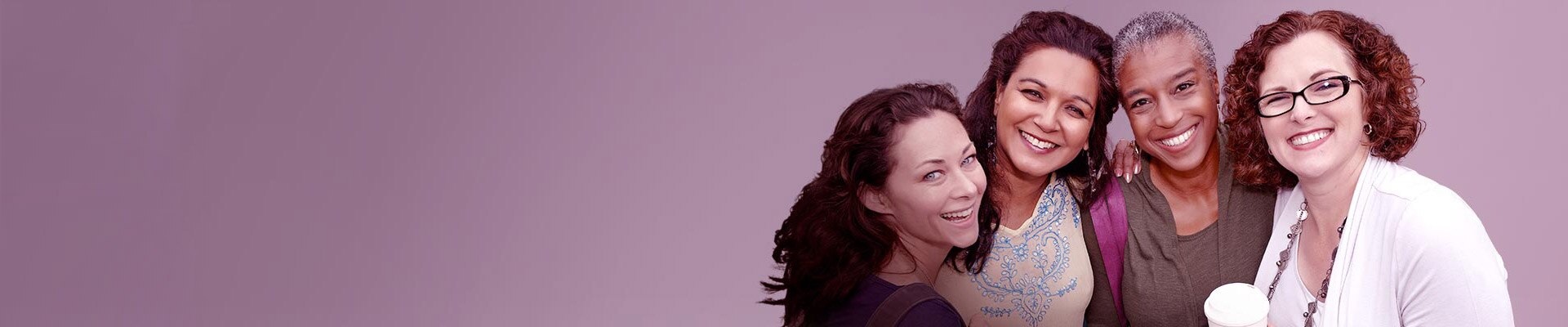 Group of medical professionals looking at a tablet.