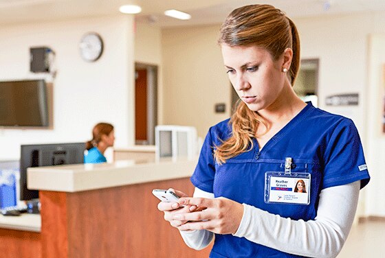 Nurse looking at mobile phone