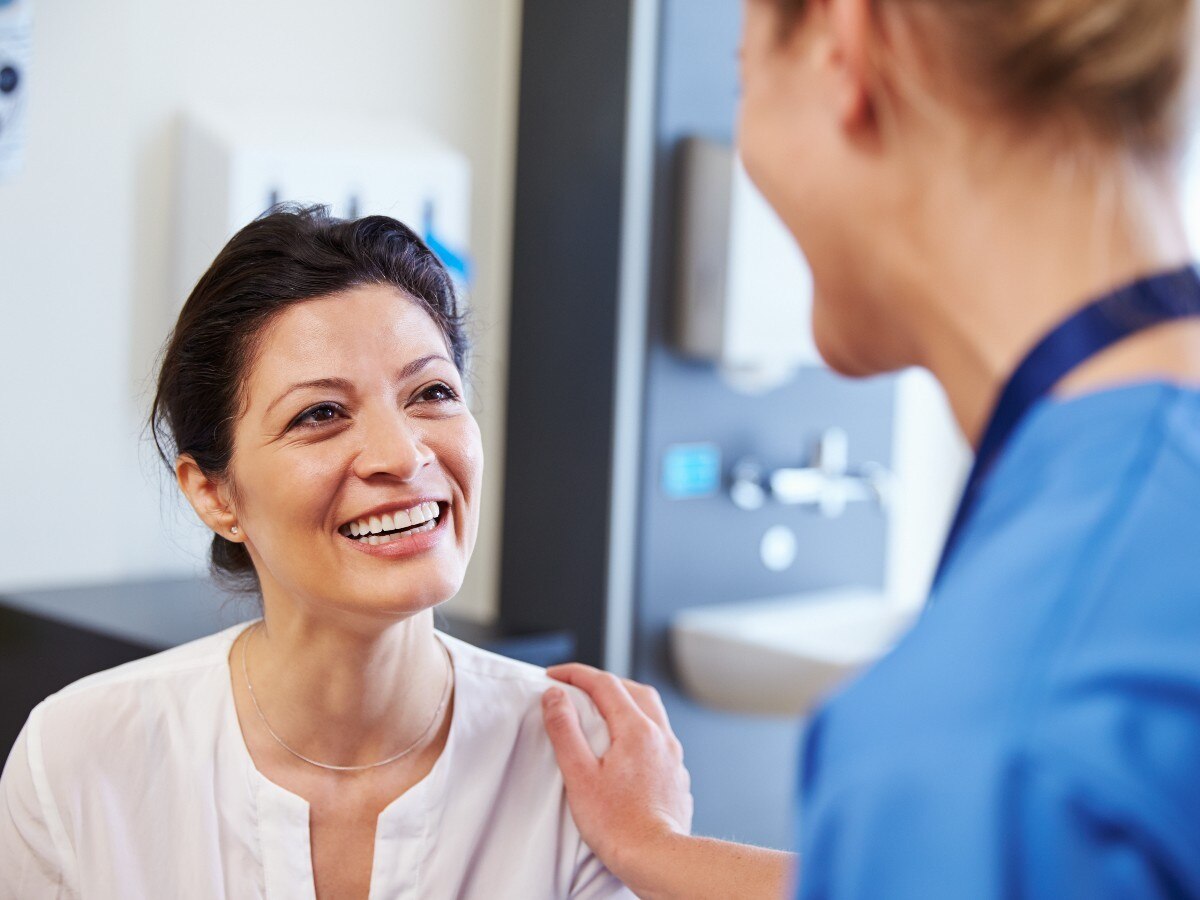 Two nurses wearing pink scrubs in a medical facility