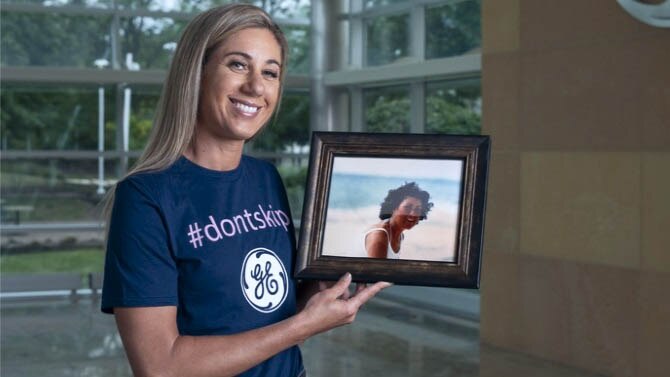 April Ross holding up a framed picture