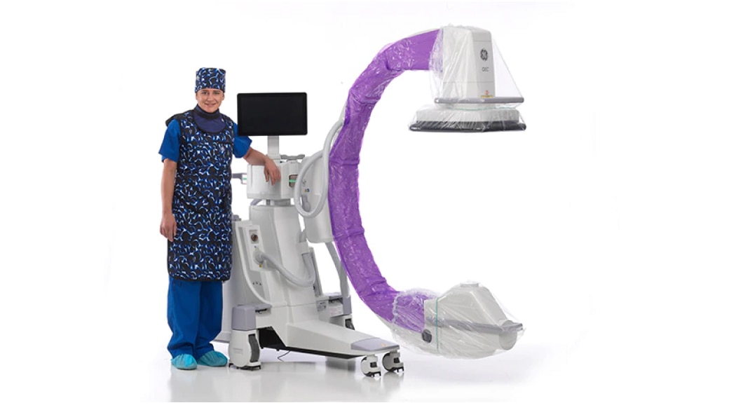 Clinician standing next to an OEC C-arm equipment