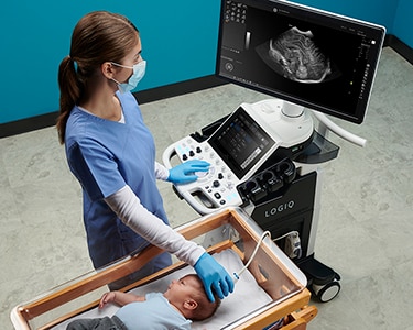 Female clinician scanning an infant's head