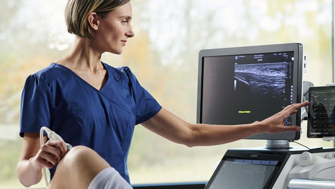 sonographer using ultrasound on patient knee