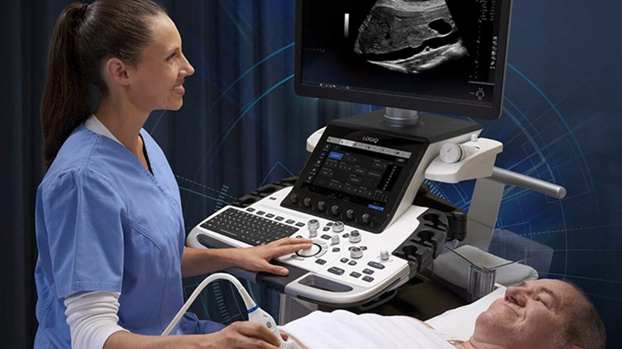Ultrasound technician performing an ultrasound on a male patient