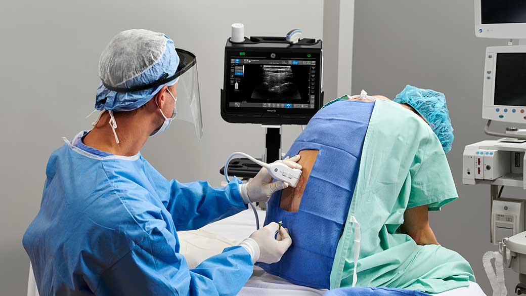 anesthesiologist using the Venue Fit to administer anesthesia into a patient's back